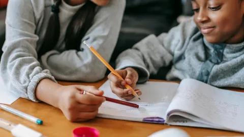 Teen helping kid with homework