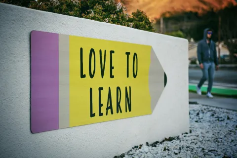 Mural of a pencil with text reading Love To Learn