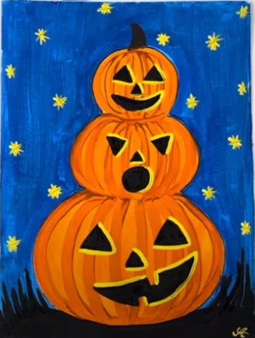 stack of three painted carved pumpkins