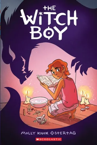 Cover of Witch Boy book. A boy is reading a book near candles