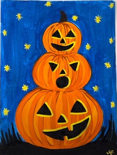 stack of three painted carved pumpkins